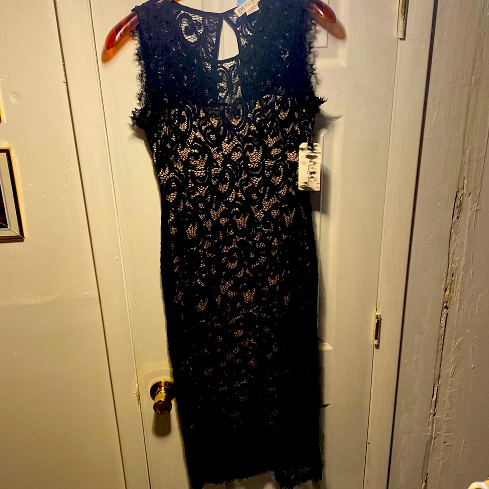 NWT Black lace overlay dress with nude color lining. Mid calf length. Sleeveless